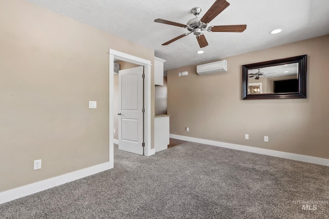carpeted empty room featuring baseboards, an AC wall unit, recessed lighting, and ceiling fan