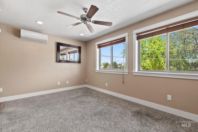 carpeted empty room featuring baseboards, a ceiling fan, a wall mounted AC, and recessed lighting