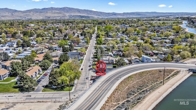 drone / aerial view featuring a water and mountain view and a residential view