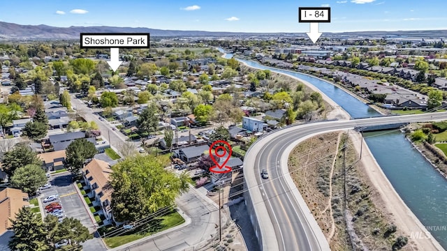birds eye view of property with a residential view and a water and mountain view
