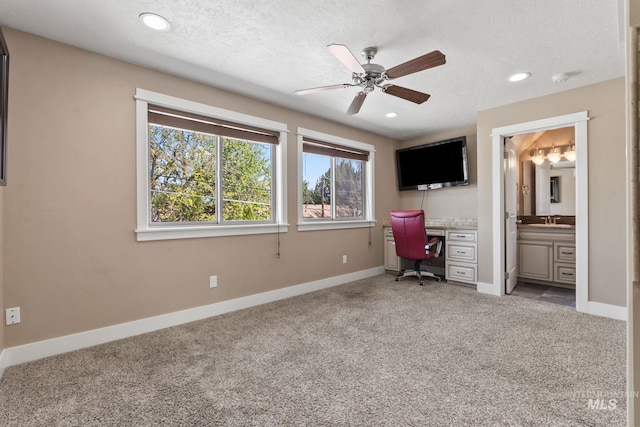 bedroom featuring a sink, connected bathroom, light carpet, baseboards, and recessed lighting