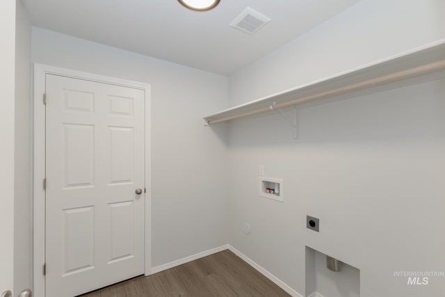 washroom with hookup for a washing machine, hardwood / wood-style flooring, and hookup for an electric dryer