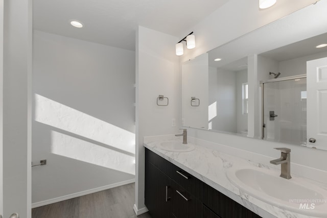 bathroom with vanity, hardwood / wood-style floors, and a shower with shower door