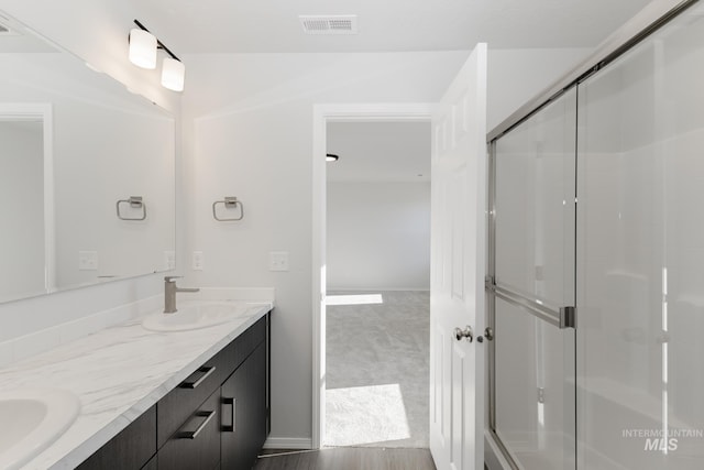 bathroom featuring vanity and walk in shower