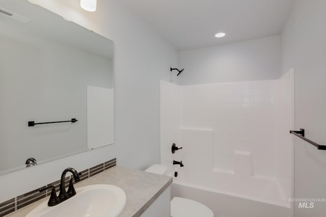 full bathroom featuring tasteful backsplash, vanity, tub / shower combination, and toilet