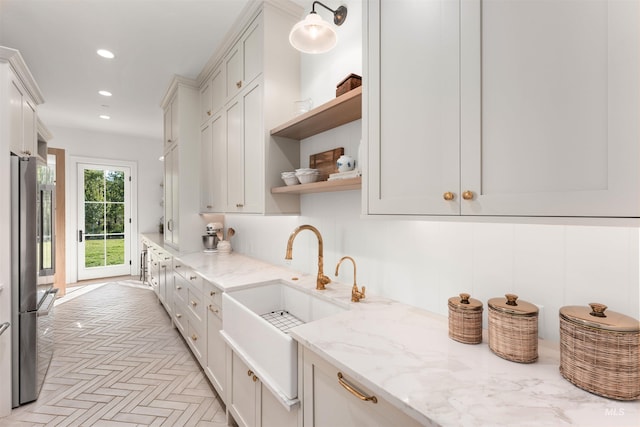 1734 S S Riparian Way, Eagle, ID 83616 - kitchen with a sink, open shelves, stainless steel fridge, recessed lighting, and light stone counters
