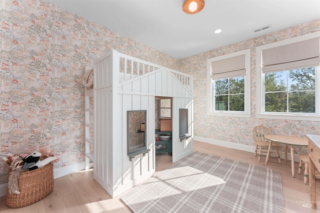 1734 S S Riparian Way, Eagle, ID 83616 - interior space with wallpapered walls, light wood-style flooring, and baseboards