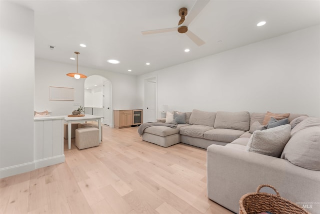 1734 S S Riparian Way, Eagle, ID 83616 - living room featuring arched walkways, light wood-style flooring, a ceiling fan, recessed lighting, and wine cooler