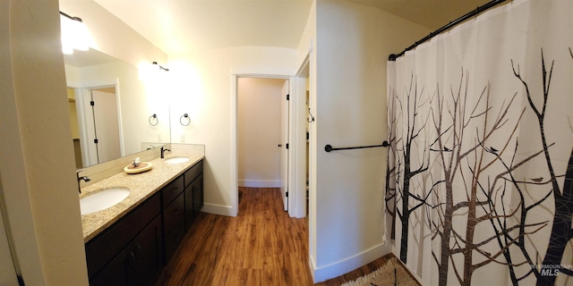 bathroom featuring double sink vanity and hardwood / wood-style flooring