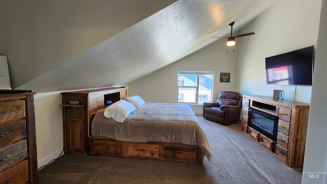 carpeted bedroom featuring ceiling fan, a textured ceiling, and lofted ceiling