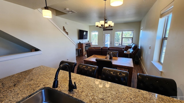 dining space featuring a chandelier and sink