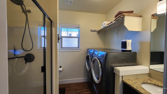 laundry room with dark hardwood / wood-style flooring and washing machine and clothes dryer