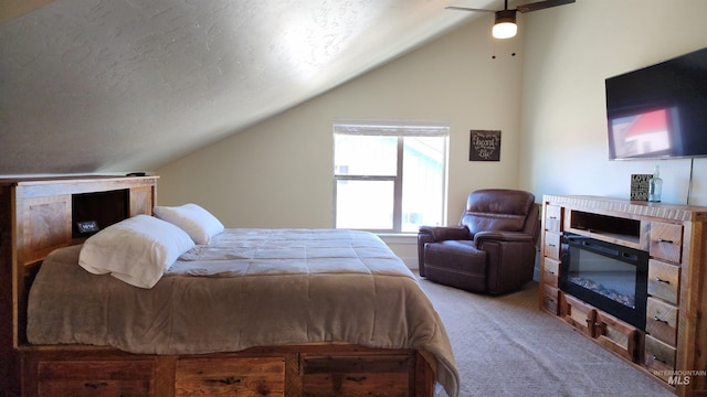 carpeted bedroom featuring ceiling fan, vaulted ceiling, and a textured ceiling