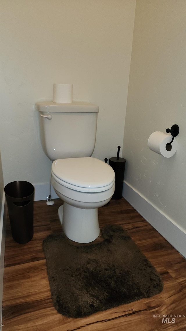 bathroom with toilet and hardwood / wood-style floors