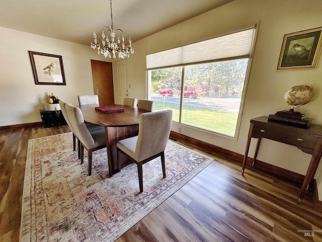 600 N 9th E, Mountain Home, ID 83647 - dining area featuring wood finished floors, a chandelier, baseboards, and lofted ceiling
