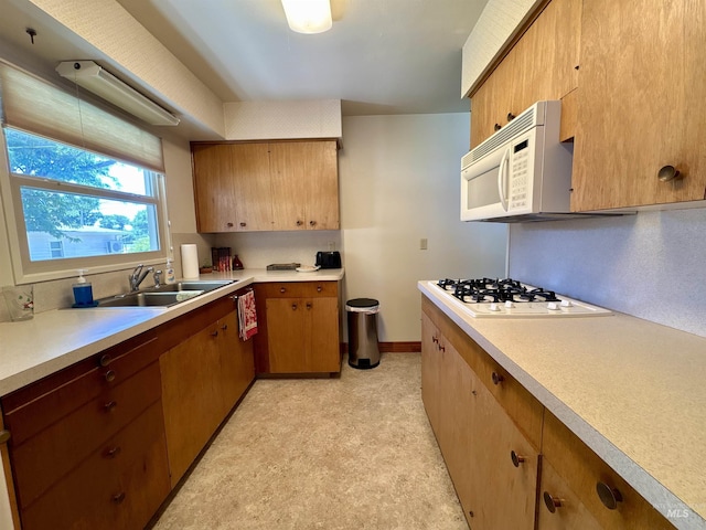 600 N 9th E, Mountain Home, ID 83647 - kitchen with white appliances, a sink, light countertops, and light floors