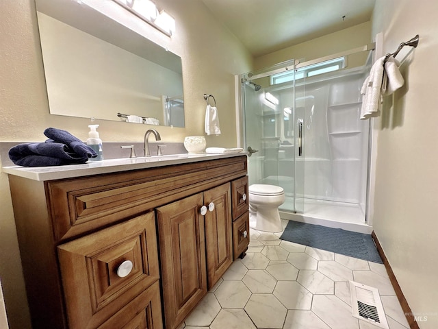600 N 9th E, Mountain Home, ID 83647 - full bath featuring vanity, a stall shower, toilet, and tile patterned flooring