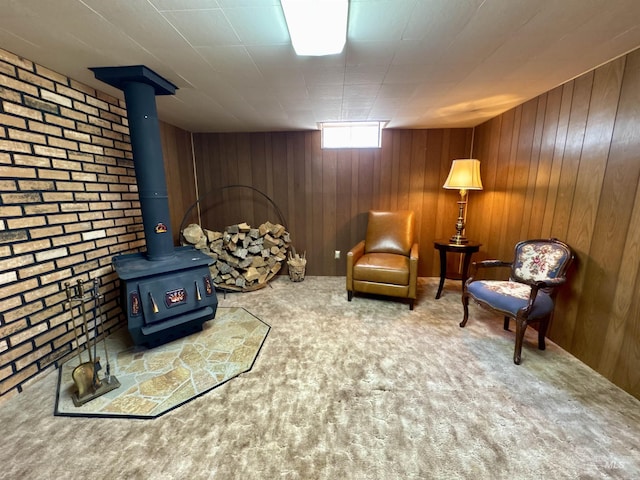 600 N 9th E, Mountain Home, ID 83647 - living area with carpet flooring, wooden walls, and a wood stove