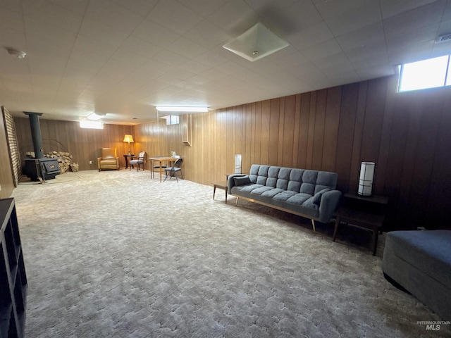 600 N 9th E, Mountain Home, ID 83647 - carpeted living room featuring a wood stove and wooden walls