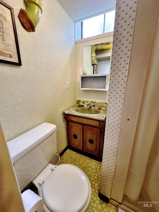 600 N 9th E, Mountain Home, ID 83647 - bathroom featuring toilet, vanity, and tile patterned floors