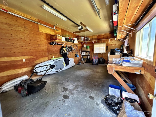 600 N 9th E, Mountain Home, ID 83647 - garage with a workshop area, a garage door opener, and wood walls