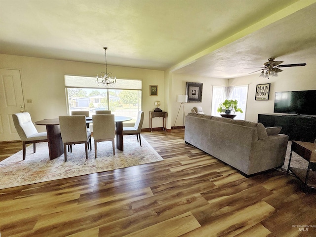 600 N 9th E, Mountain Home, ID 83647 - dining room featuring a chandelier, wood finished floors, ceiling fan, and baseboards