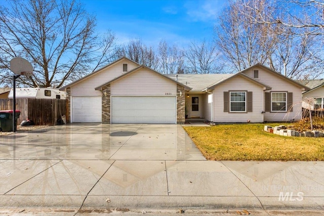 ranch-style home featuring an attached garage, brick siding, fence, driveway, and a front lawn