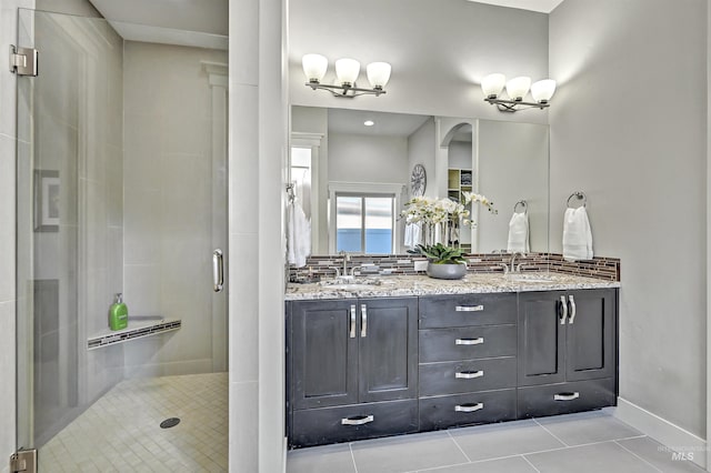 bathroom featuring walk in shower, vanity, and tile patterned floors