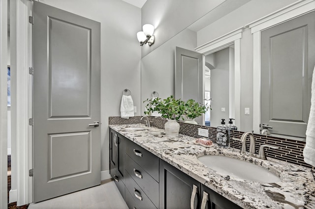 bathroom featuring tasteful backsplash and vanity