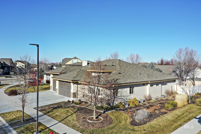 view of front of house featuring a front yard and a garage