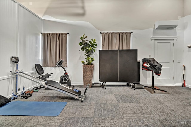 workout area featuring an AC wall unit and carpet flooring