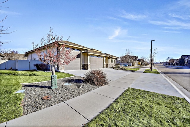 ranch-style home with a front yard and a garage