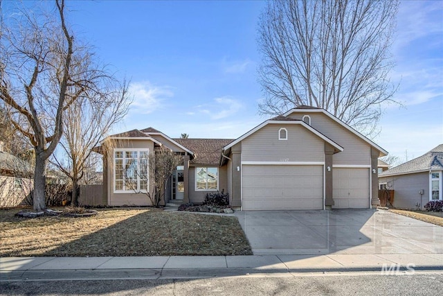 ranch-style house with a garage, driveway, and fence