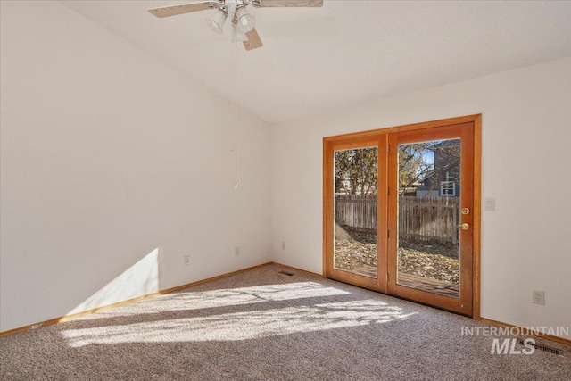 spare room with carpet floors, lofted ceiling, ceiling fan, and baseboards