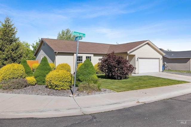 1590 Saddler St, Twin Falls, ID 83301 - ranch-style house with an attached garage, concrete driveway, and a front lawn