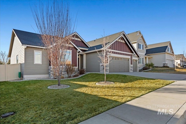 craftsman house featuring concrete driveway, an attached garage, board and batten siding, fence, and a front lawn