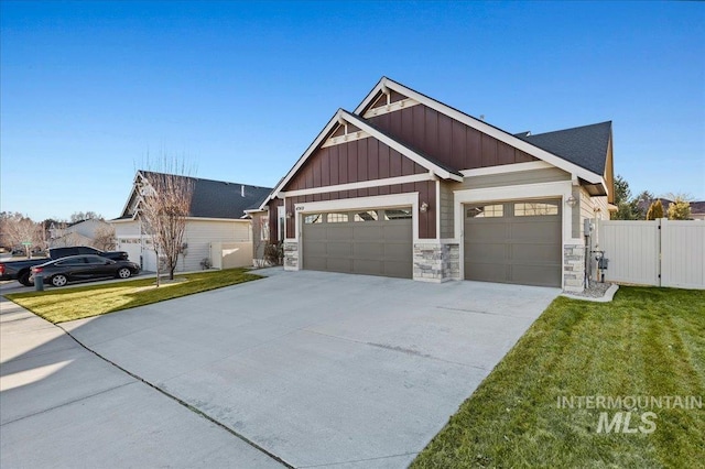 craftsman house with an attached garage, concrete driveway, stone siding, board and batten siding, and a front yard