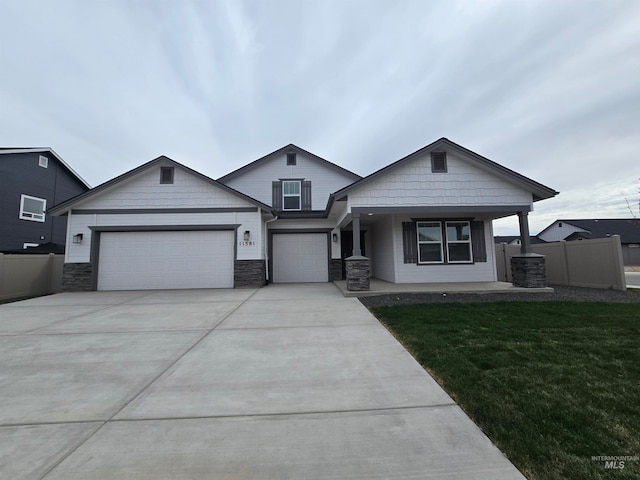 11581 W Trooper St, Nampa, ID 83651 - view of front of house featuring concrete driveway, a garage, fence, and a front lawn