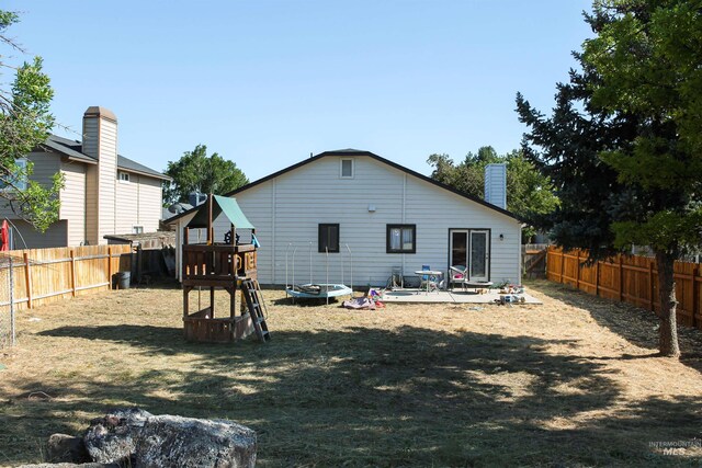 1396 W Crest Wood Dr, Meridian, ID 83642 - rear view of property with a fenced backyard, a patio area, and a chimney