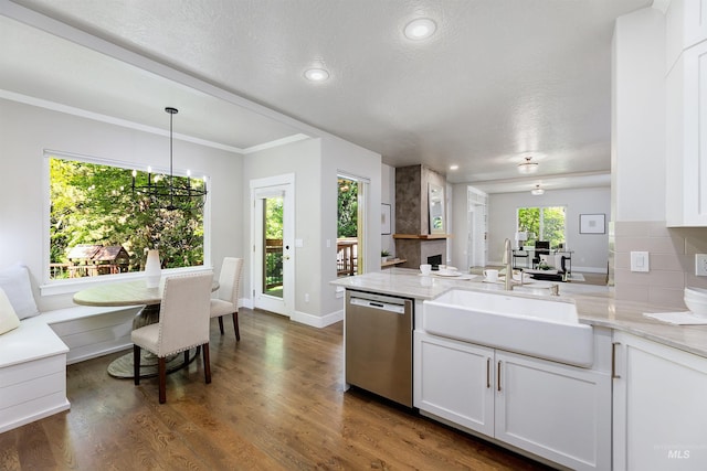 2383 E Lenox Ct, Eagle, ID 83616 - kitchen featuring stainless steel dishwasher, a sink, a peninsula, white cabinets, and light stone counters