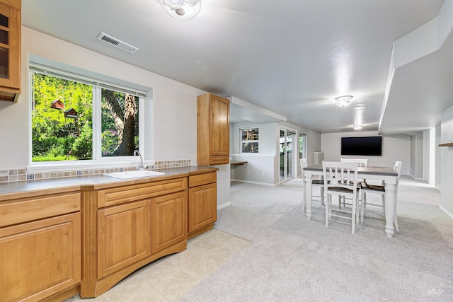 2383 E Lenox Ct, Eagle, ID 83616 - kitchen featuring a sink, plenty of natural light, light carpet, and baseboards