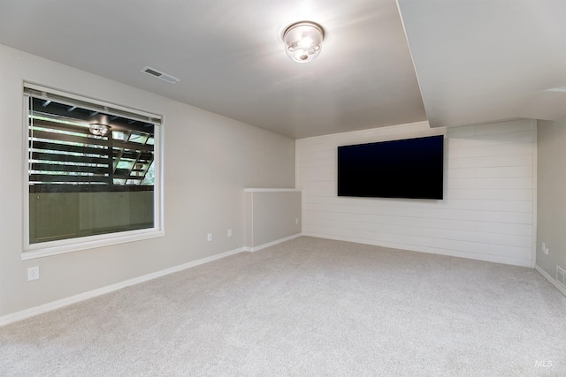 2383 E Lenox Ct, Eagle, ID 83616 - unfurnished living room featuring carpet floors, wooden walls, and baseboards