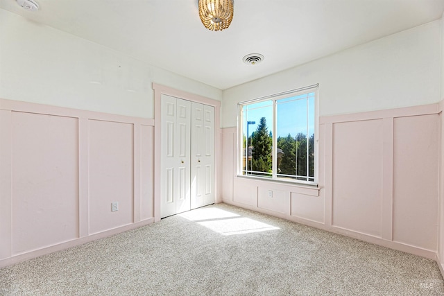 2383 E Lenox Ct, Eagle, ID 83616 - unfurnished bedroom with a decorative wall, carpet flooring, and a wainscoted wall