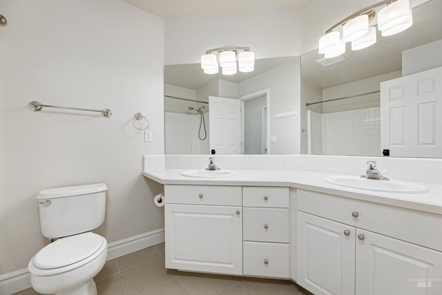 2383 E Lenox Ct, Eagle, ID 83616 - bathroom with double vanity, toilet, a shower, tile patterned flooring, and baseboards