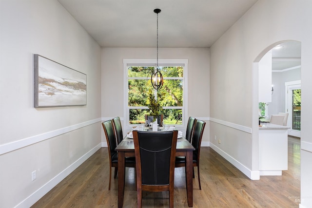 2383 E Lenox Ct, Eagle, ID 83616 - dining space featuring arched walkways, wood finished floors, healthy amount of natural light, and baseboards