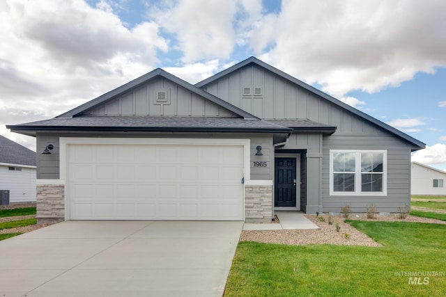 5315 E Burnte Peak St, Nampa, ID 83687 - view of front of property featuring board and batten siding, driveway, an attached garage, and a front yard