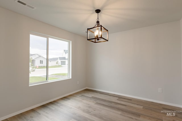 5315 E Burnte Peak St, Nampa, ID 83687 - unfurnished room featuring plenty of natural light, a chandelier, light wood-style flooring, and baseboards