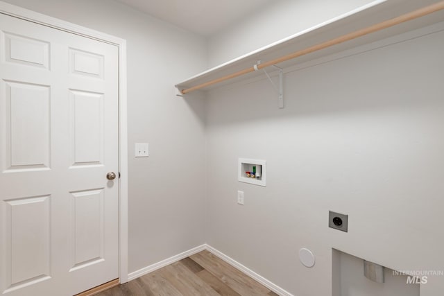 5315 E Burnte Peak St, Nampa, ID 83687 - laundry area with hookup for an electric dryer, hookup for a washing machine, light wood-style flooring, and baseboards