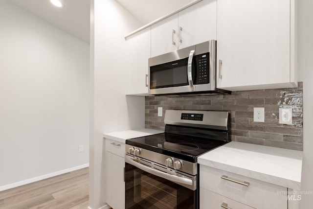 5315 E Burnte Peak St, Nampa, ID 83687 - kitchen with appliances with stainless steel finishes, light countertops, backsplash, white cabinets, and recessed lighting