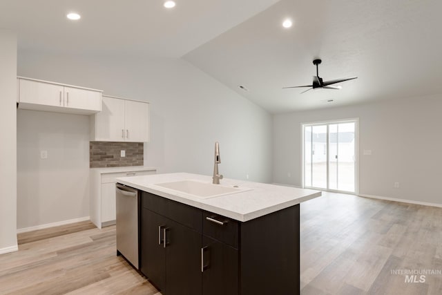5315 E Burnte Peak St, Nampa, ID 83687 - kitchen featuring stainless steel dishwasher, a sink, vaulted ceiling, light wood-style floors, and tasteful backsplash